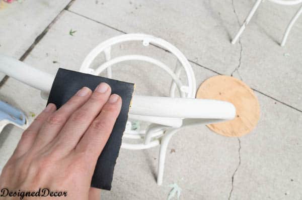 hand sanding metal chairs before spray painting