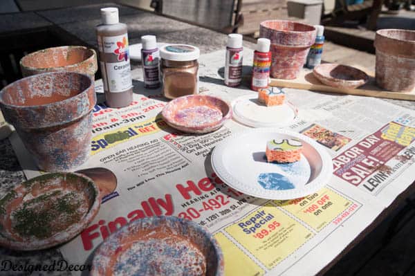 using sponges to  paint flower clay pots