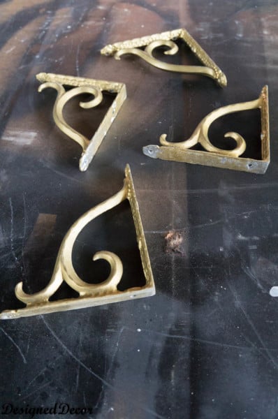 spray painting the brackets for  a Mantle Shelf-