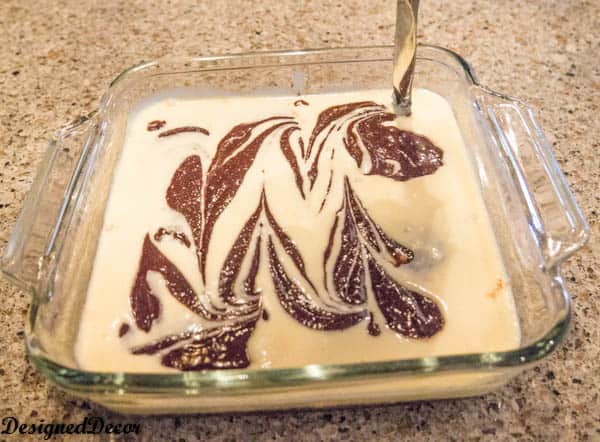 using a knife to swirl brownie batter