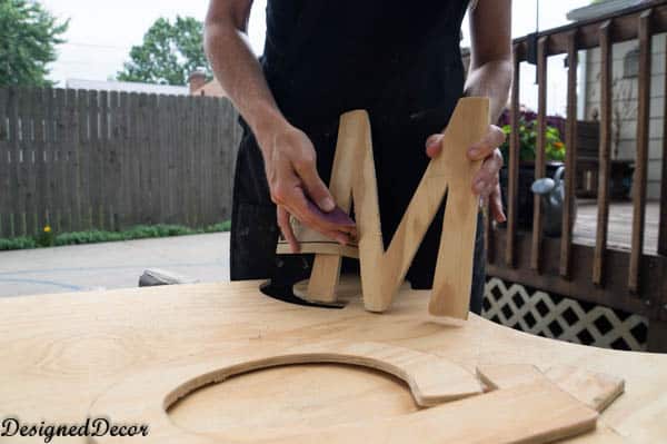 sanding down the edges of the wall letters-