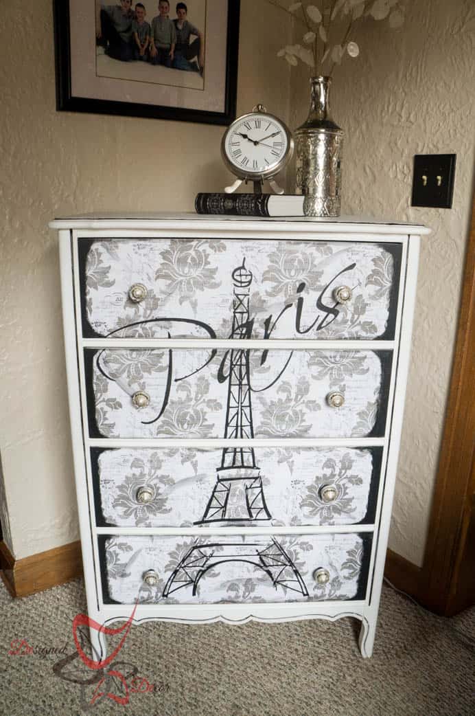 white painted dresser with an Eiffel tower graphic on the front