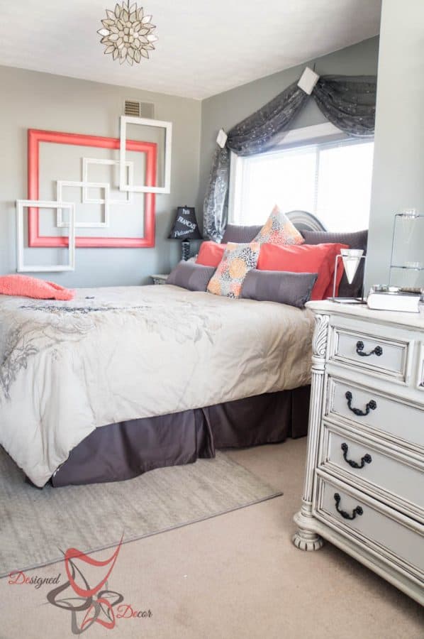 guest bedroom with painted furniture and rug under the queen bed