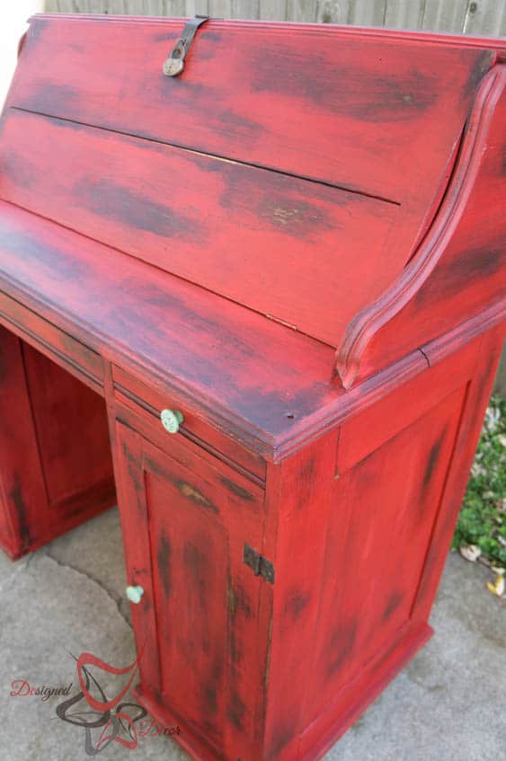 antique desk painted in heavily distressed red paint