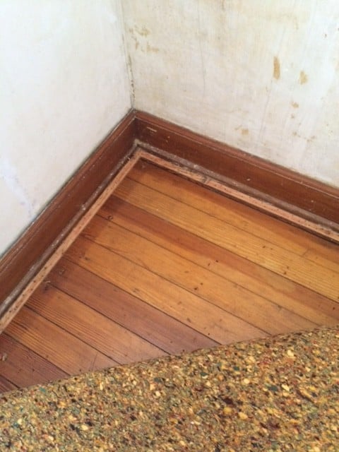 removing carpet to reveal hardwood flooring