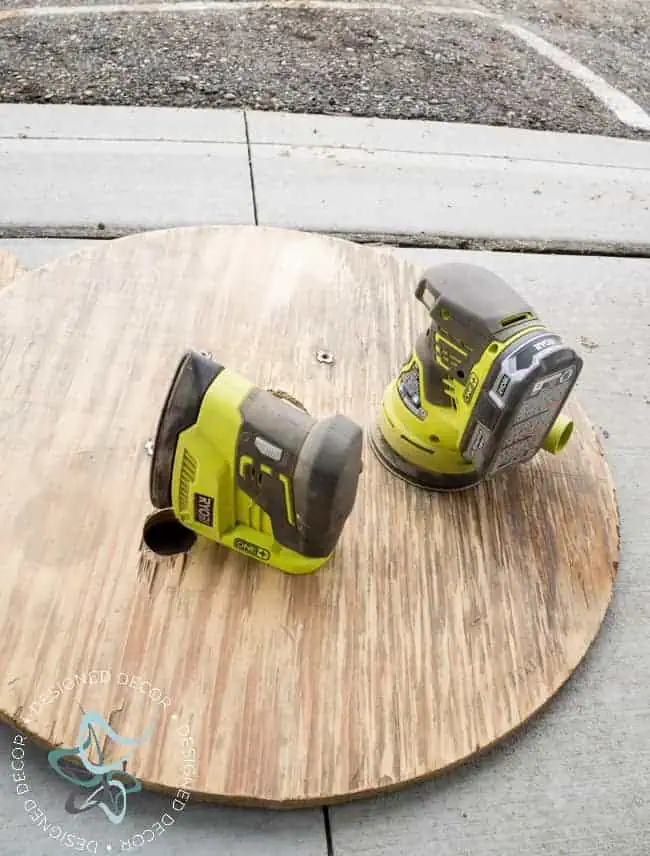 Repurposed-Electric-Spool-Table-ryobi-sanders sanding the wood on cable spool top