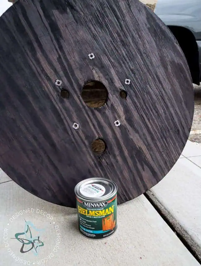 Repurposed-Electric-Spool-Table-Helmsman staining the wood on spool