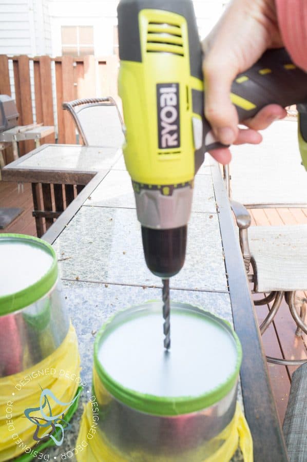 drilling holes in metal bucket for a DIY Vertical Herb Garden