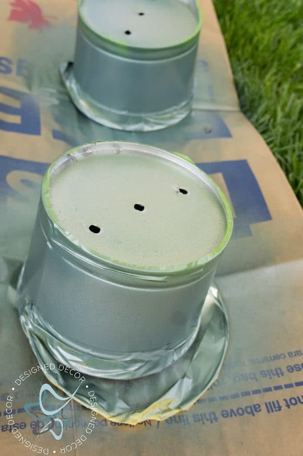 spray painting a metal bucket 