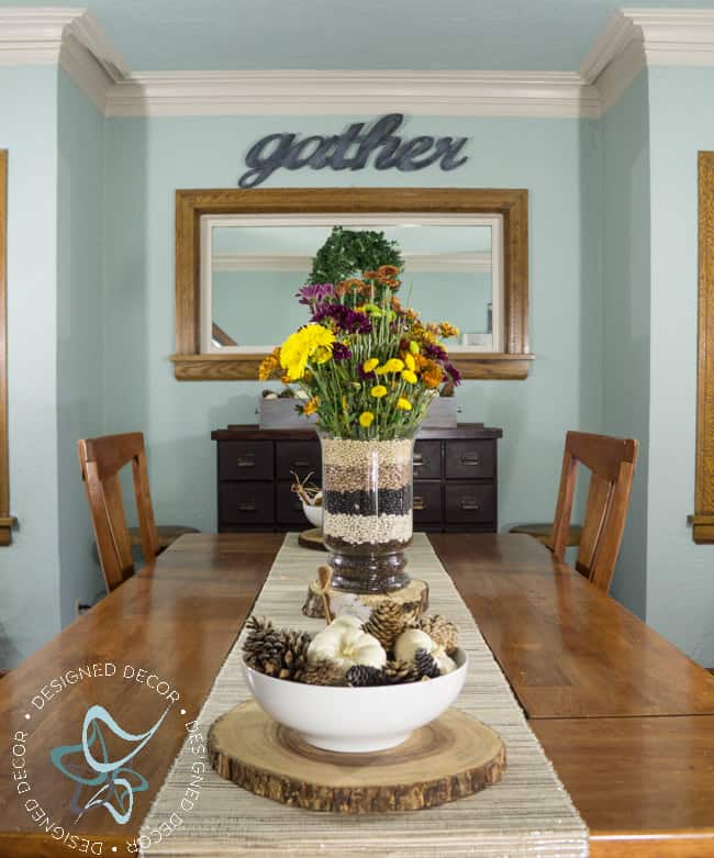 dining room table with a fall tablescape and floral centerpiece