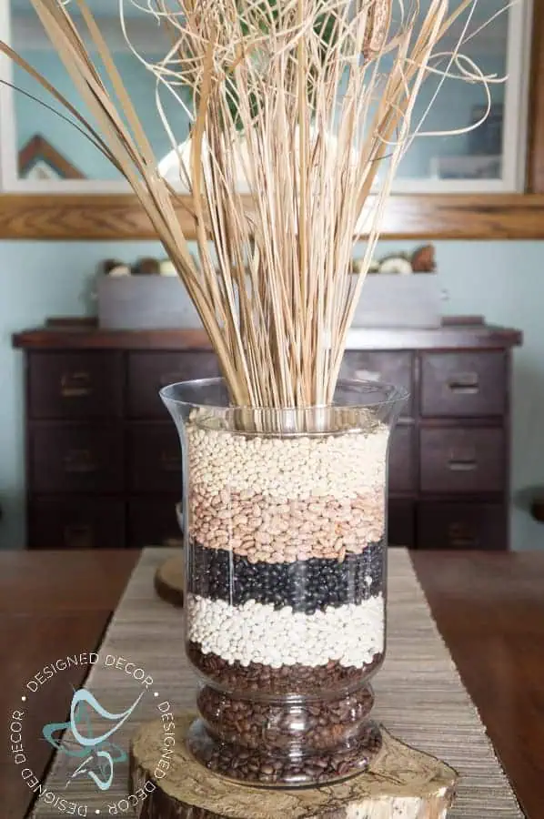 fall-decor-tablescape-centerpiece-easy-inexpensive-Diy Wood Slice glass vase filled with layers of dried beans and dried fall floral