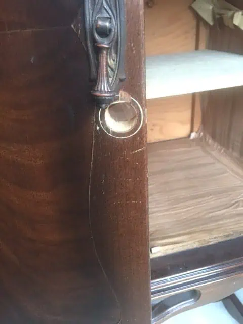 repair small holes in cabinet doors by using a wood dowle rod and wood putty