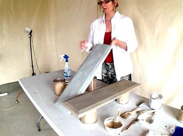 a lady painting boards with furniture paint 