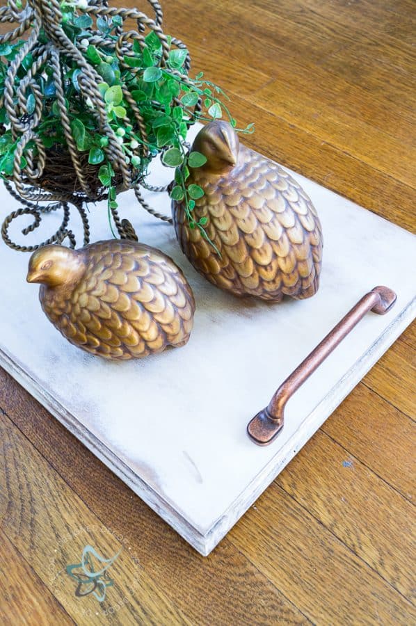 image of a repurposed serving tray with decorative quail birds on the tray