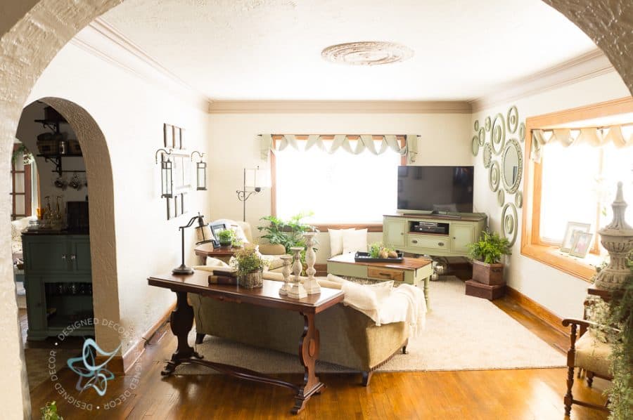 living room with hardwood floors, textured plaster walls, antique furniture and modern decorative accessories. 