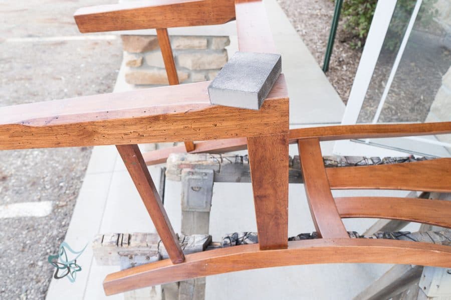 wood chair being sanded with a sanding block