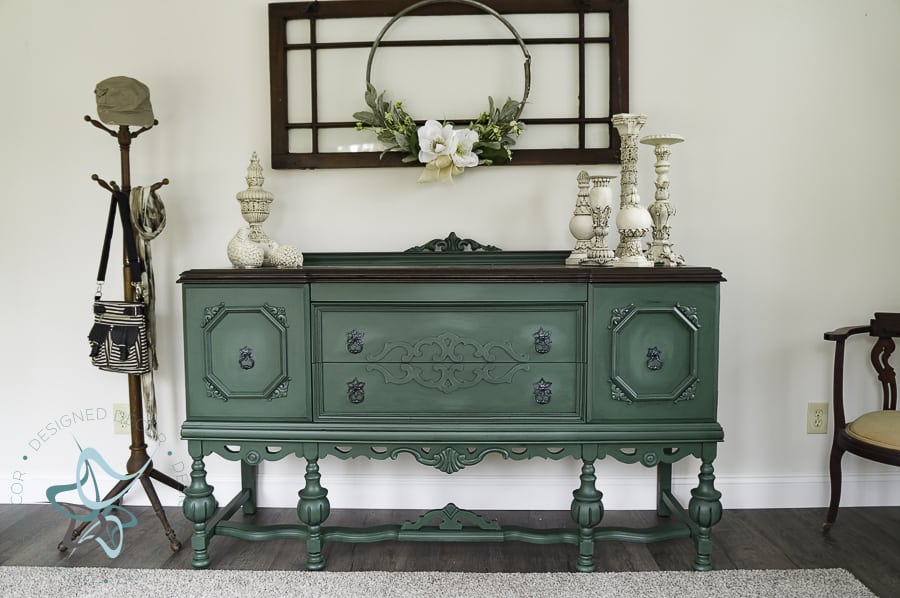 Bold modern entryway with a green painted antique buffet