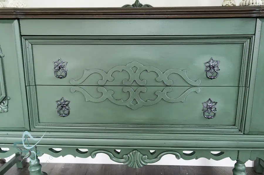 adding highlights with paint close up of a green painted buffet