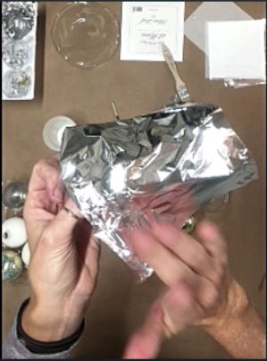 add silver leaf to ornament with tacky adhesive