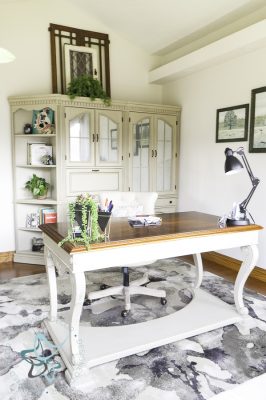 view of home office painted desk and cabinets