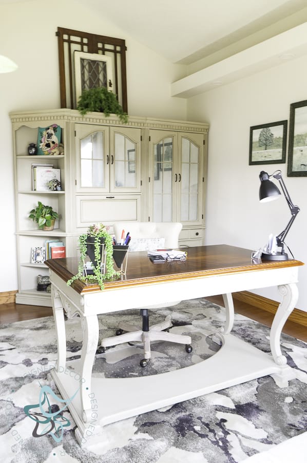 view of home office desk with shelving in background