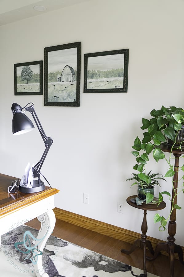 hand painted barn scene in picture frames with plant stands in the corner