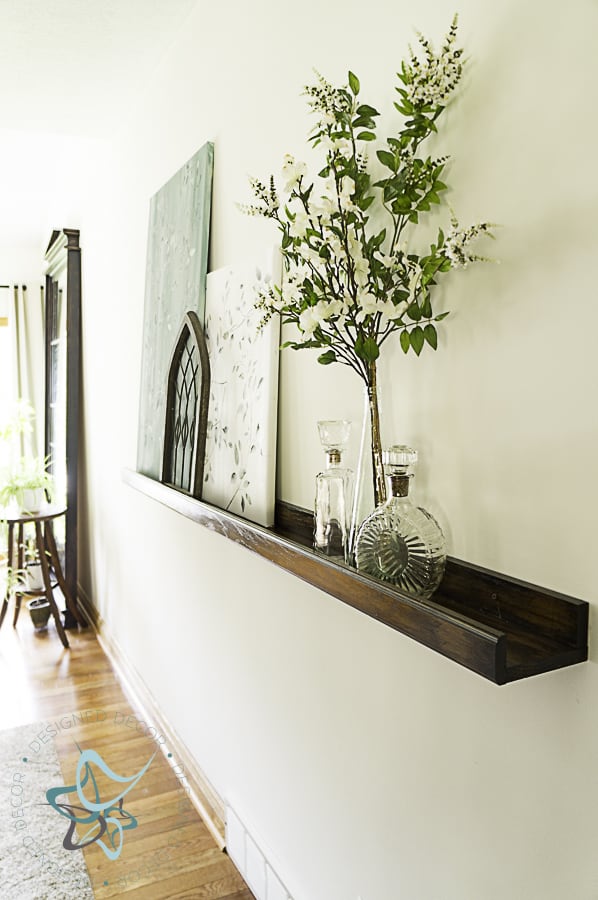 image of a picture ledge with wall art and decorative accessories