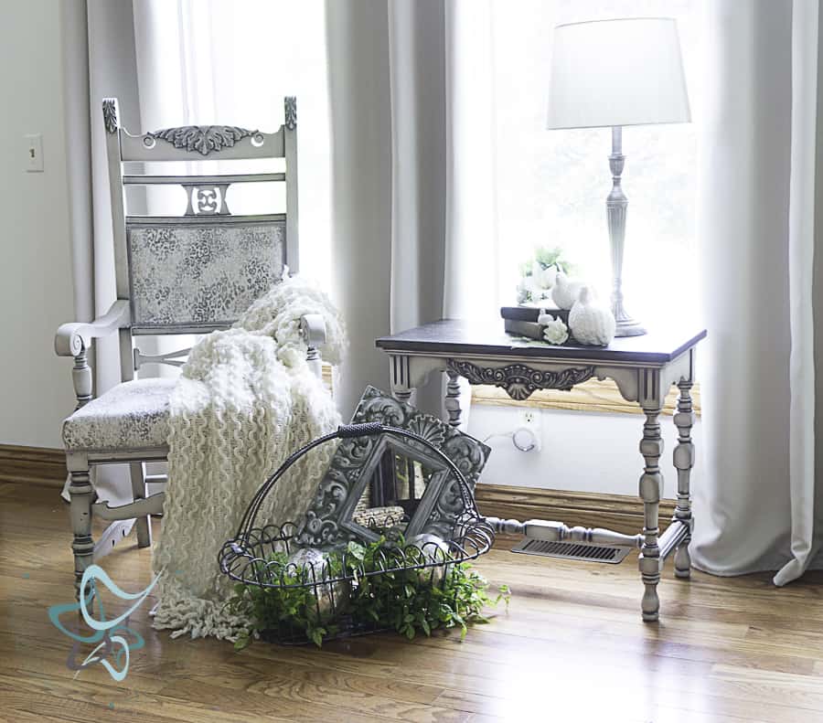 antique accent chair with blankets and a basket