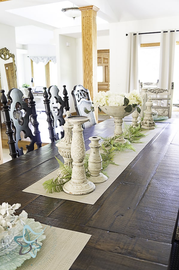 aged layered candlestick holders displayed on dining room table