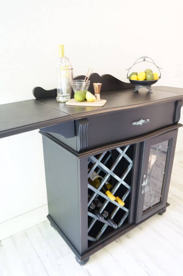image of a refinished drop leaf wine bar painted in black with patina metal accents
