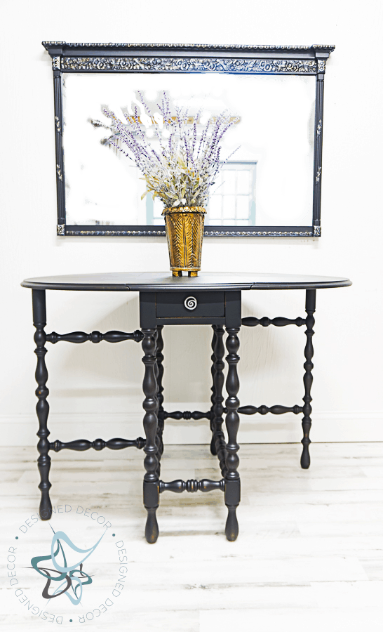 image of a dropleaf spindle leg table painted in classic black furniture paint.