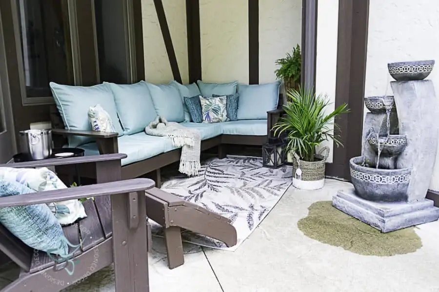 image of an outdoor seating area with a DIY outdoor sectional sofa with decorative accessories