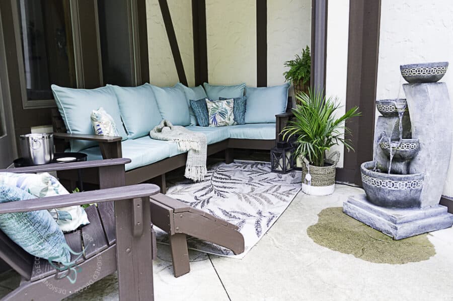 image of a patio seating area with a sectional sofa and Adirondack chair
