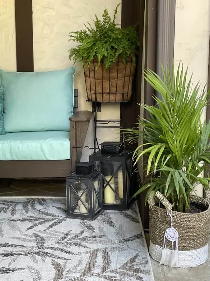 Image of a DIY outdoor sectional sofa with lanterns and plants