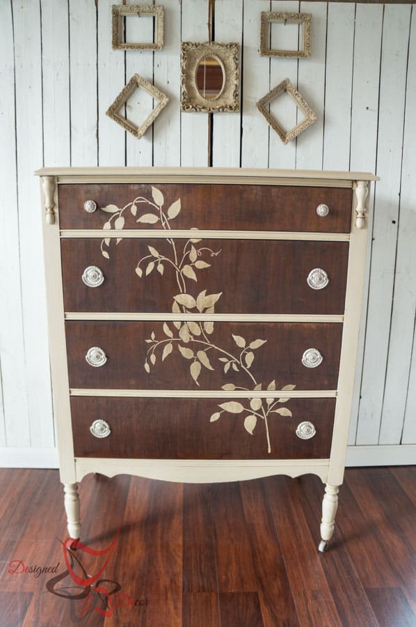 wood dresser painted with cream furniture paint and a stenciled vine of the front of the dresser drawers
