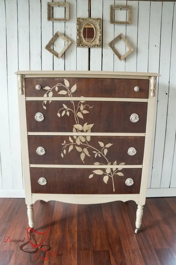 wood dresser painted with cream furniture paint and a stenciled vine of the front of the dresser drawers