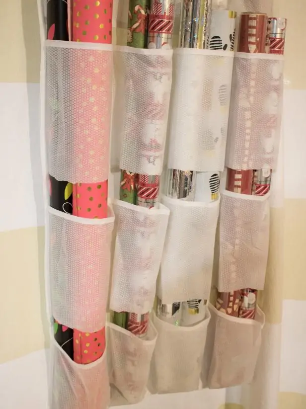 using a door shoe organizer to hold tubes of wrapping paper