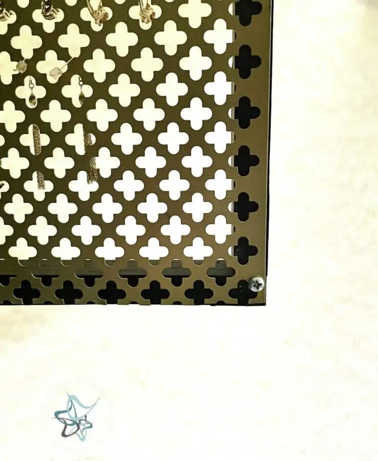 gold decorative metal sheet screwed into a wood frame