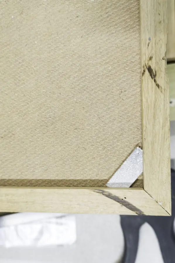 close up image of fiber board backing with support hardware inserted in the corner