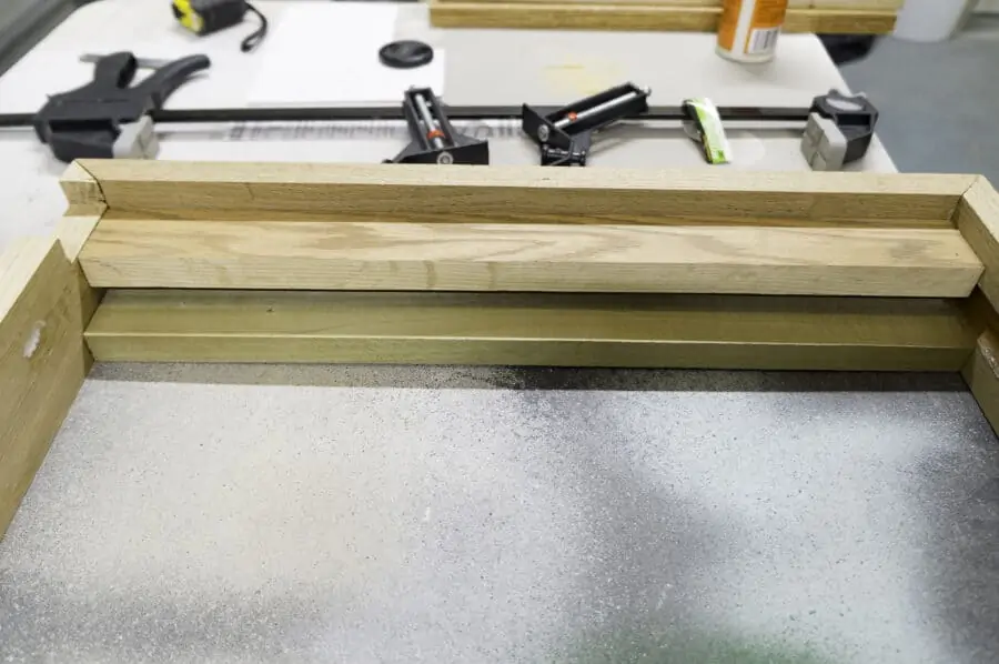 close up image of the wood support bar for the top of the jewelry cabinet frame