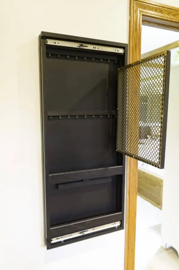 jewelry storage cabinet being hung on a wall