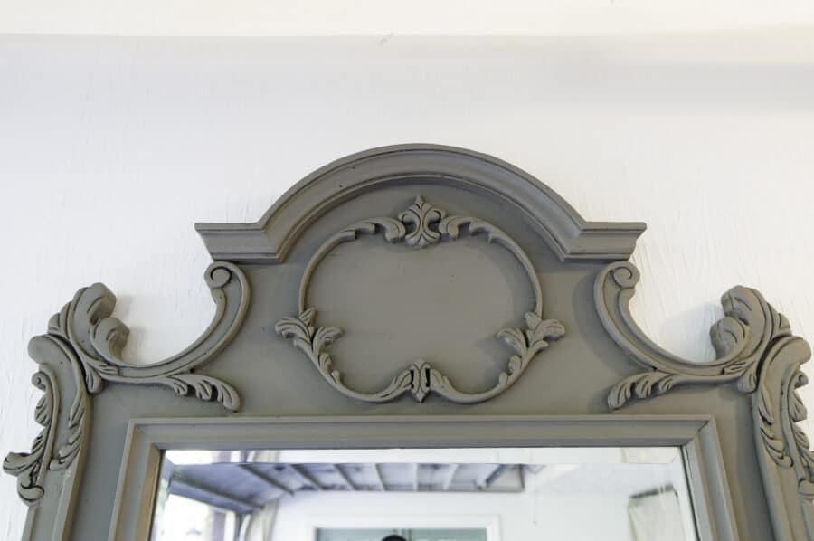 close up image of the scroll details on a mirror frame