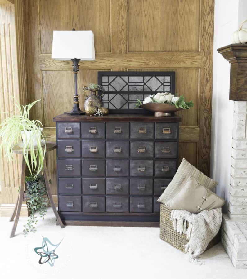 antique apothecary cabinet decorated for fall