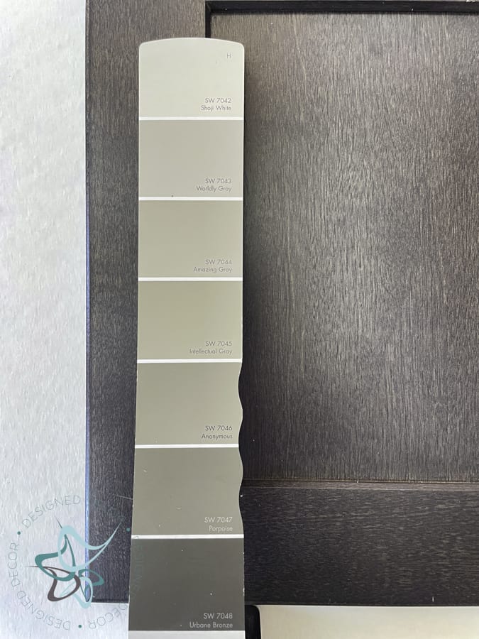 cabinet door with a paint swatch strip laying on top