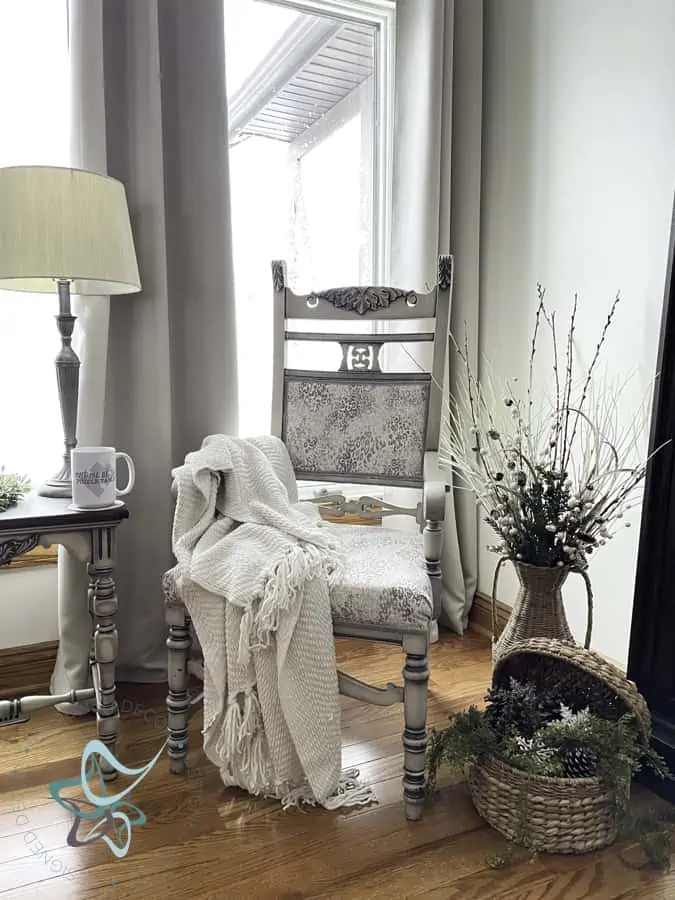 Antique accent chair with a blanket and baskets