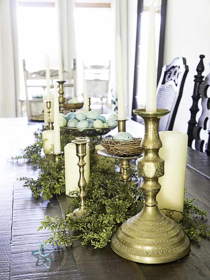 Spring Tablescape with candles, greenery and birds nests 