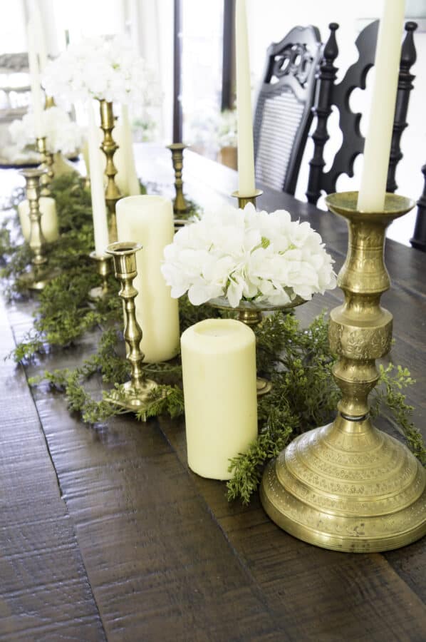summer dining tablescape of greenery, candles and hydrangeas
