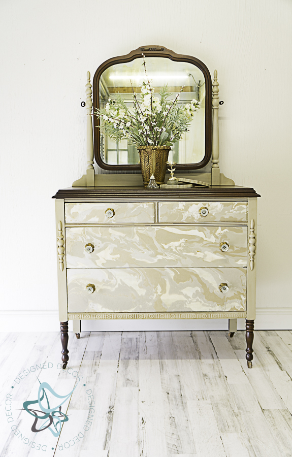 antique dresser painted with a paint pour furniture technique 