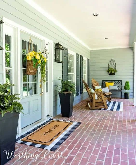 front porch with a welcome mat and rocking chairs