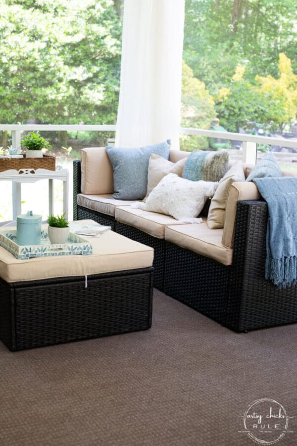brown wicker patio furniture with cream pillows